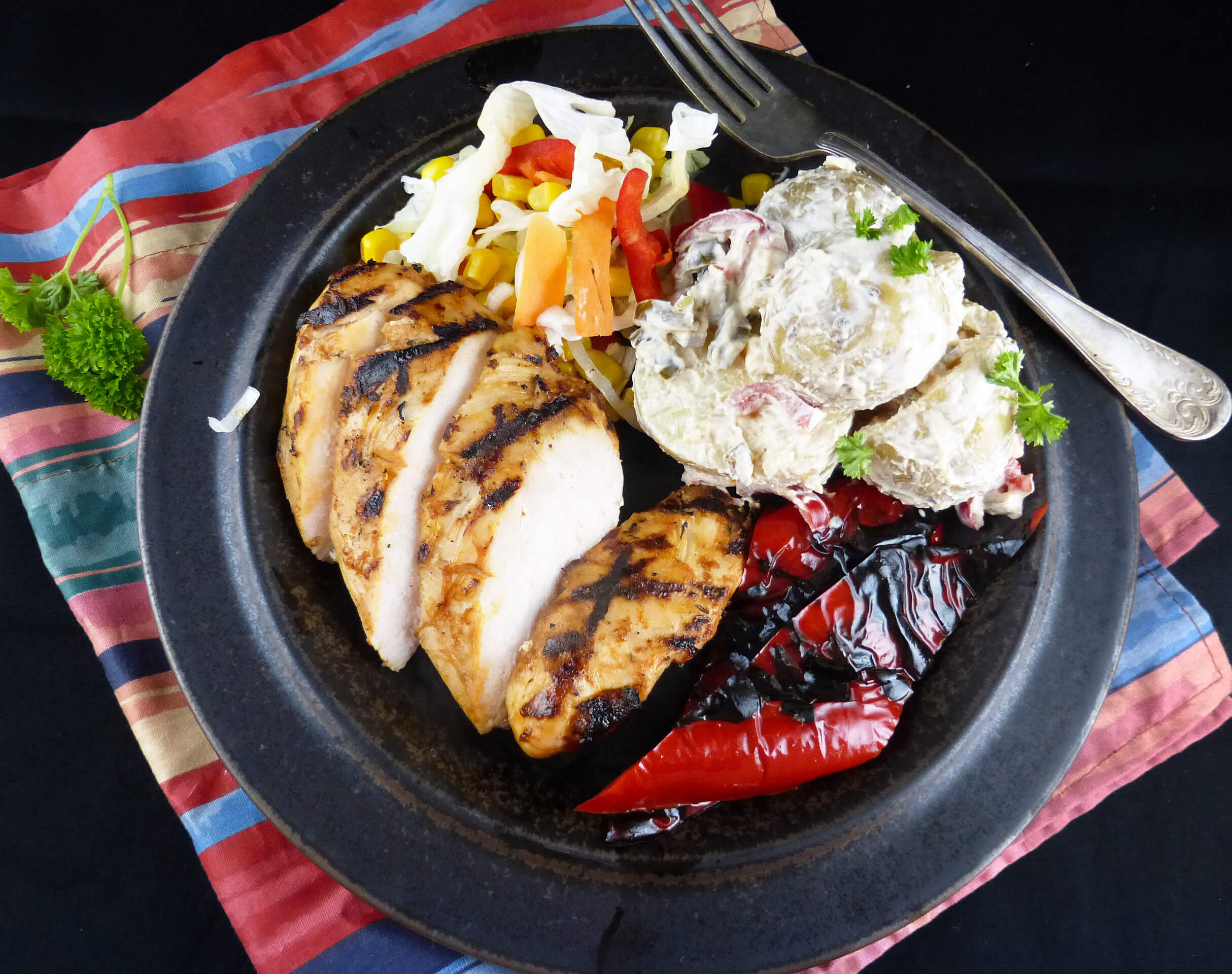 picture of grilled chicken with potato salad and vegetables