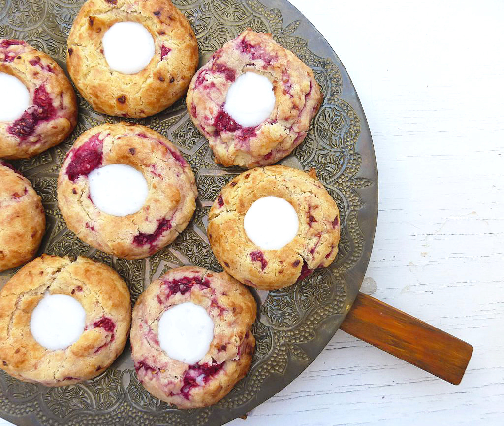 plate of thumbprint cookies on a white surface