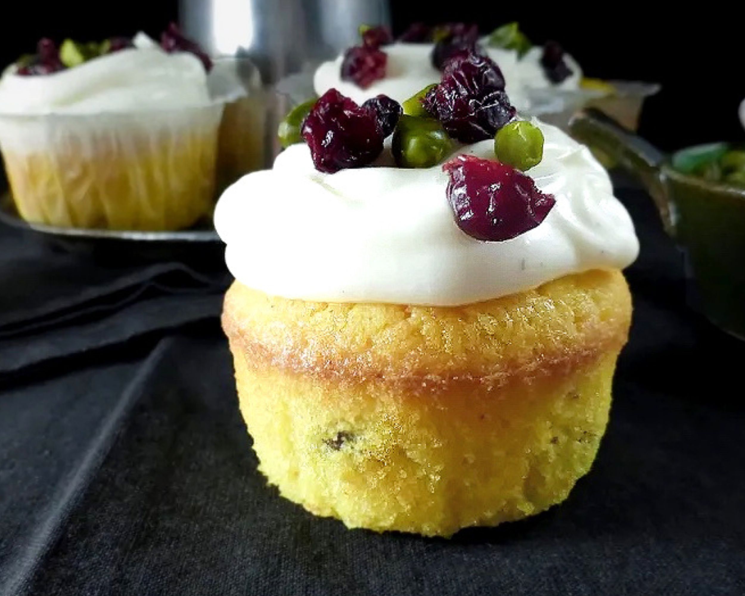 yellow saffronc cupcake close up with a black background