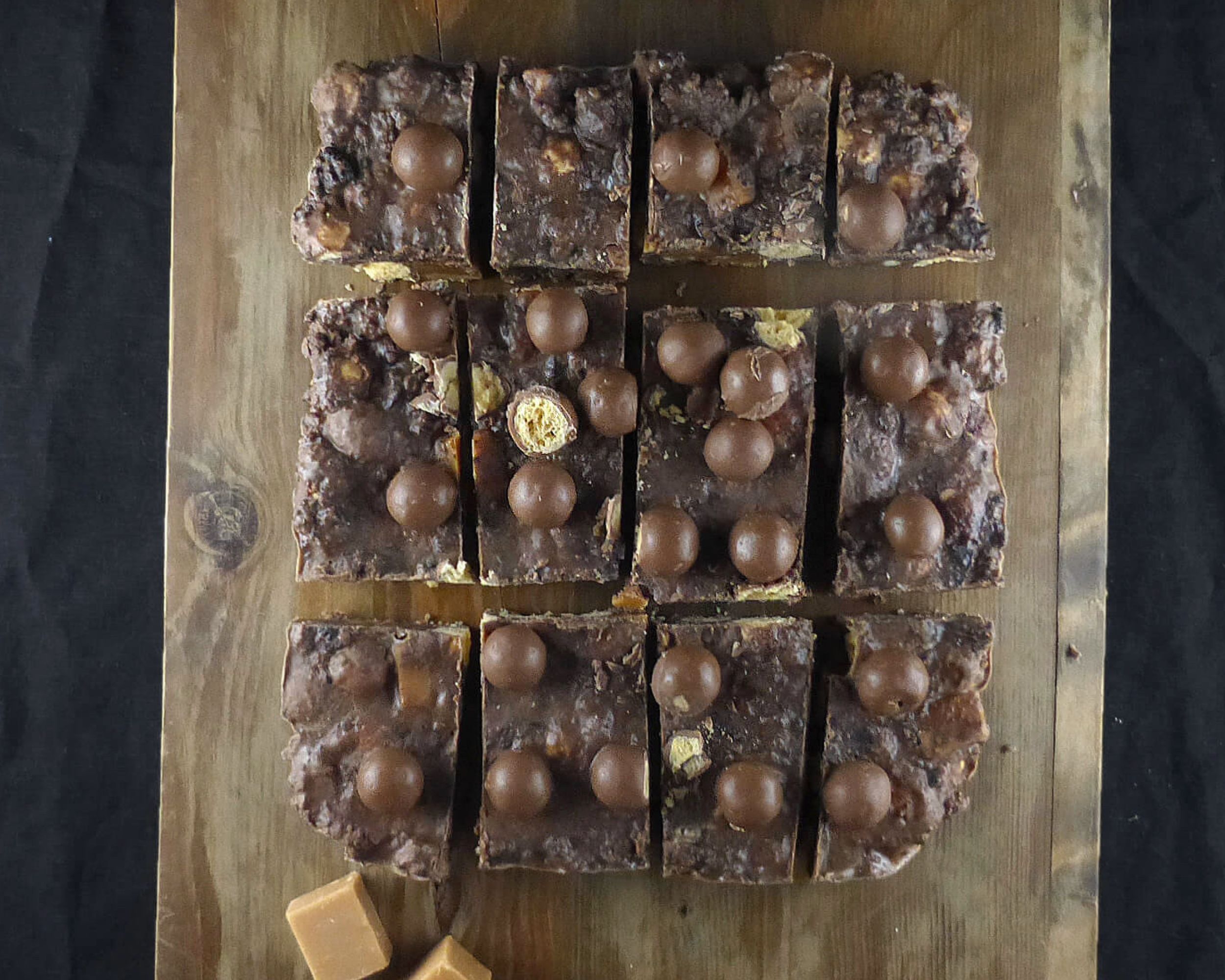 overhead shot of no bake chocolate slices on a wooden board