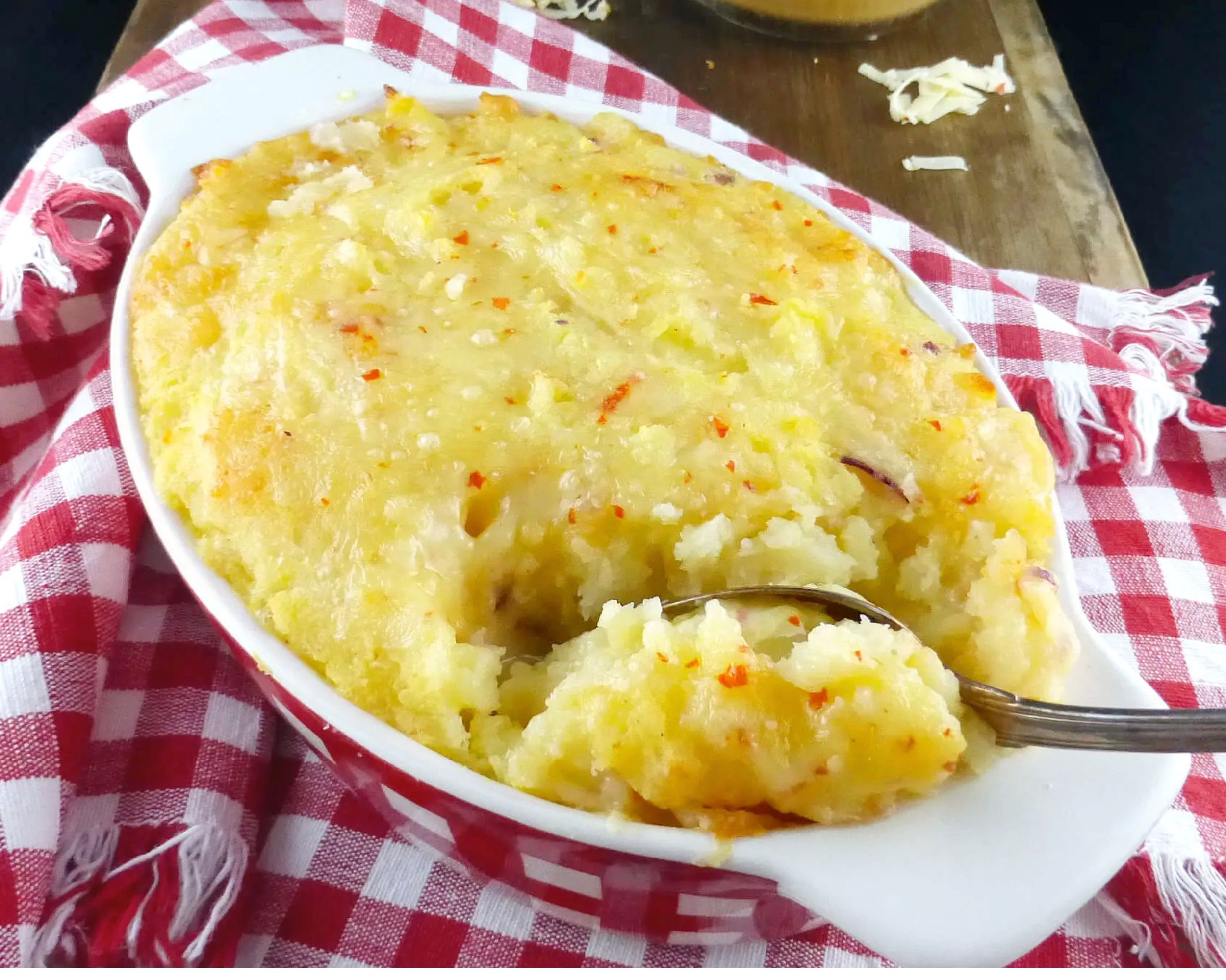 mashed potato in an oven dish on a red and white checked cloth