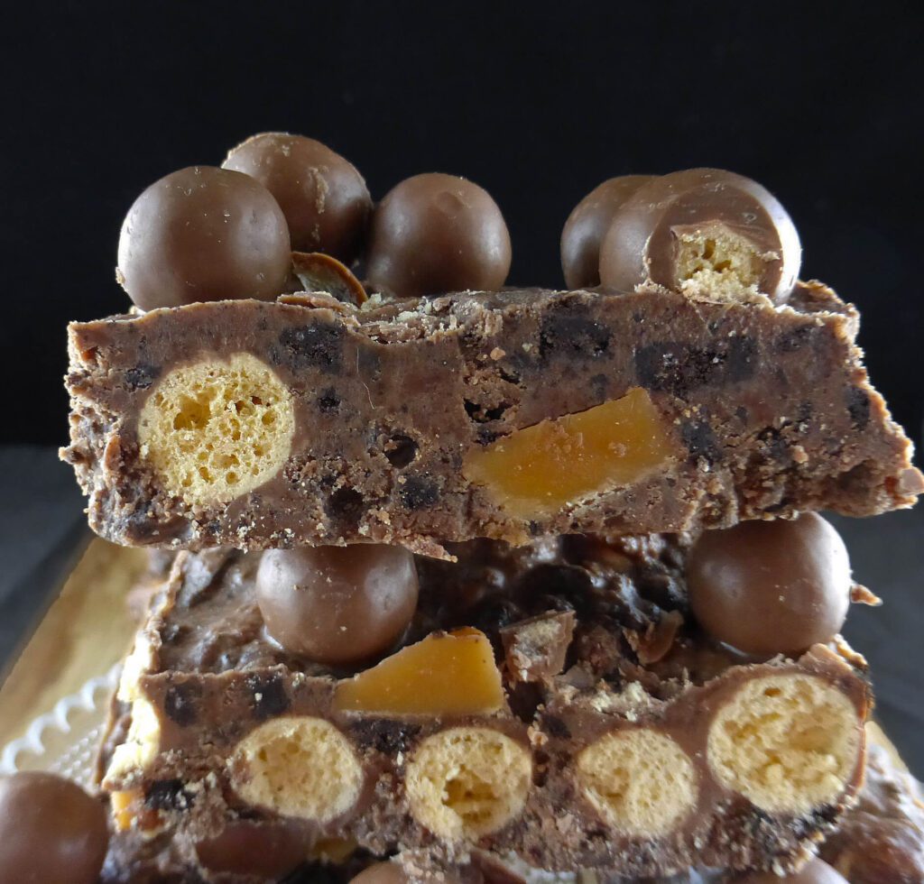 close up of a chocolate slice with Maltesers, Oreos and fudge