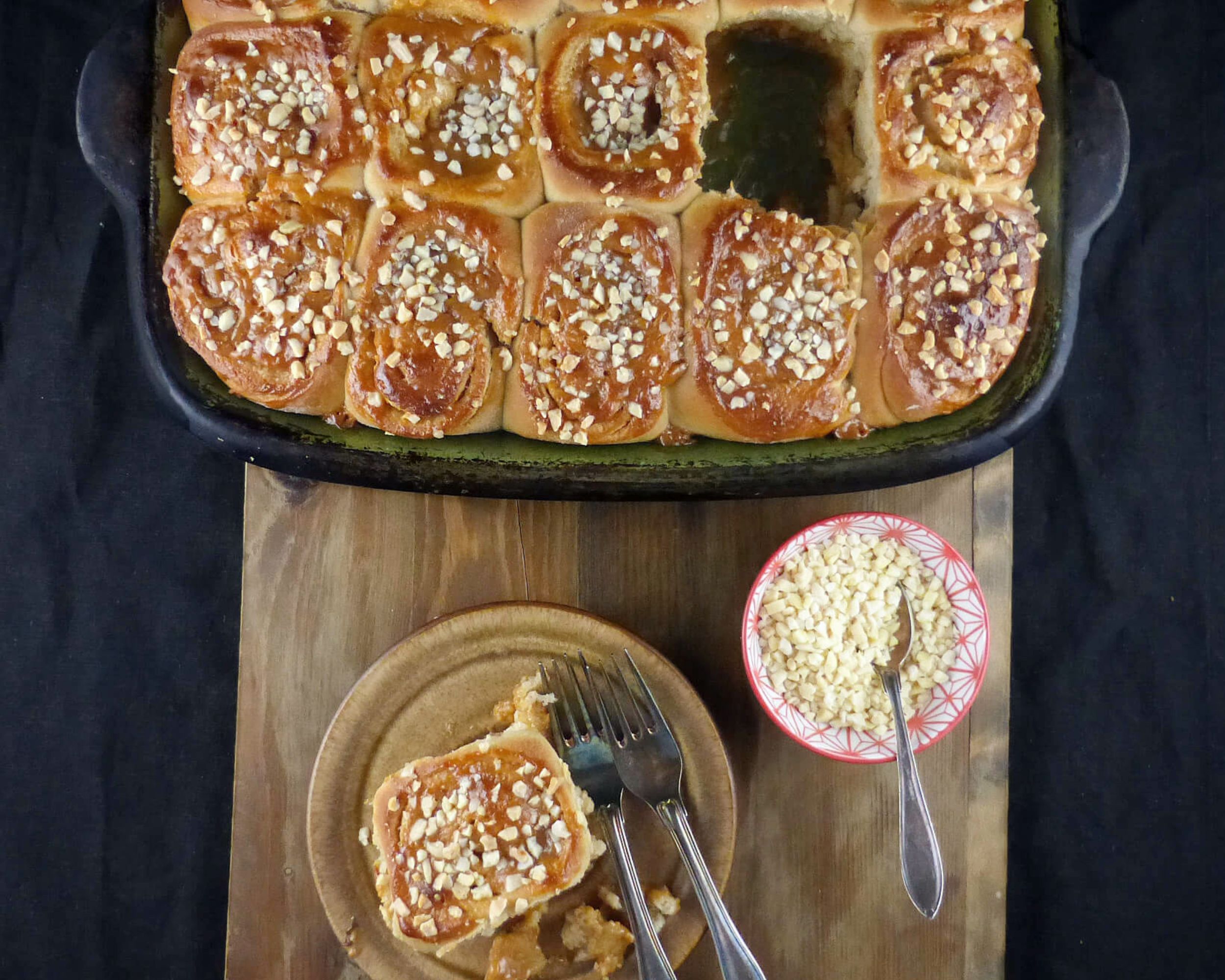 overhead shot of sticky buns on a wooden board