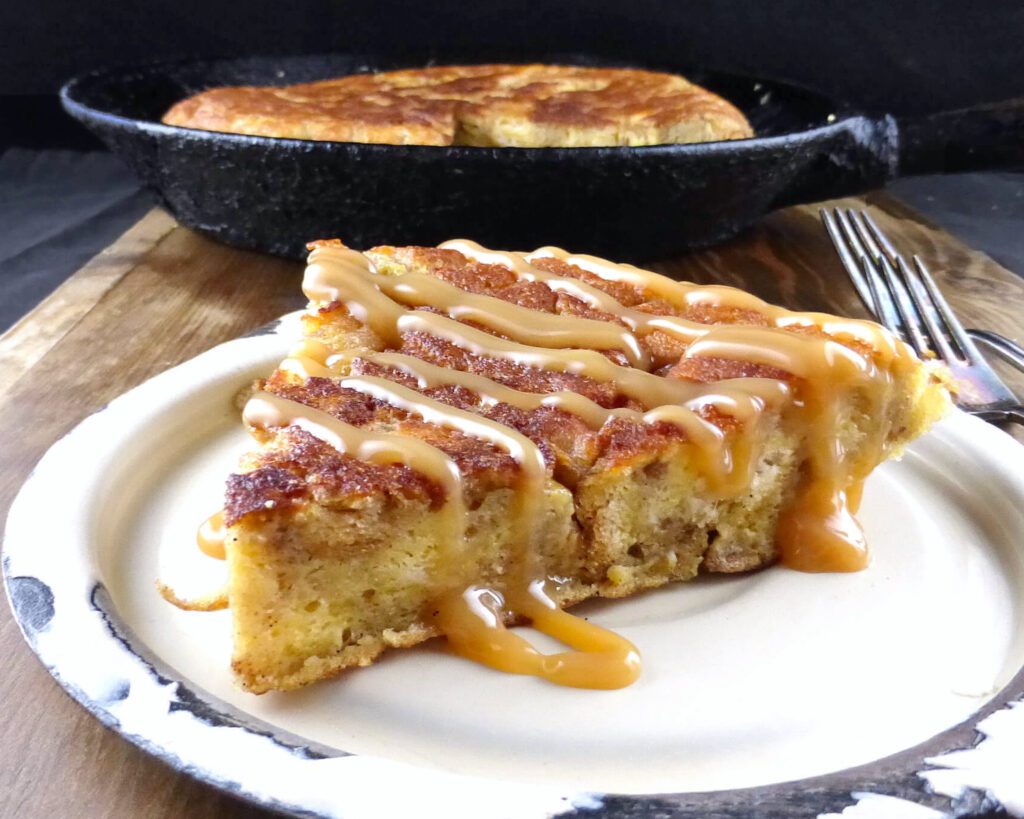 slice of sweet eggy bread on a beige plate and wooden board