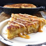 eggy bread with a slice cut on a wooden board