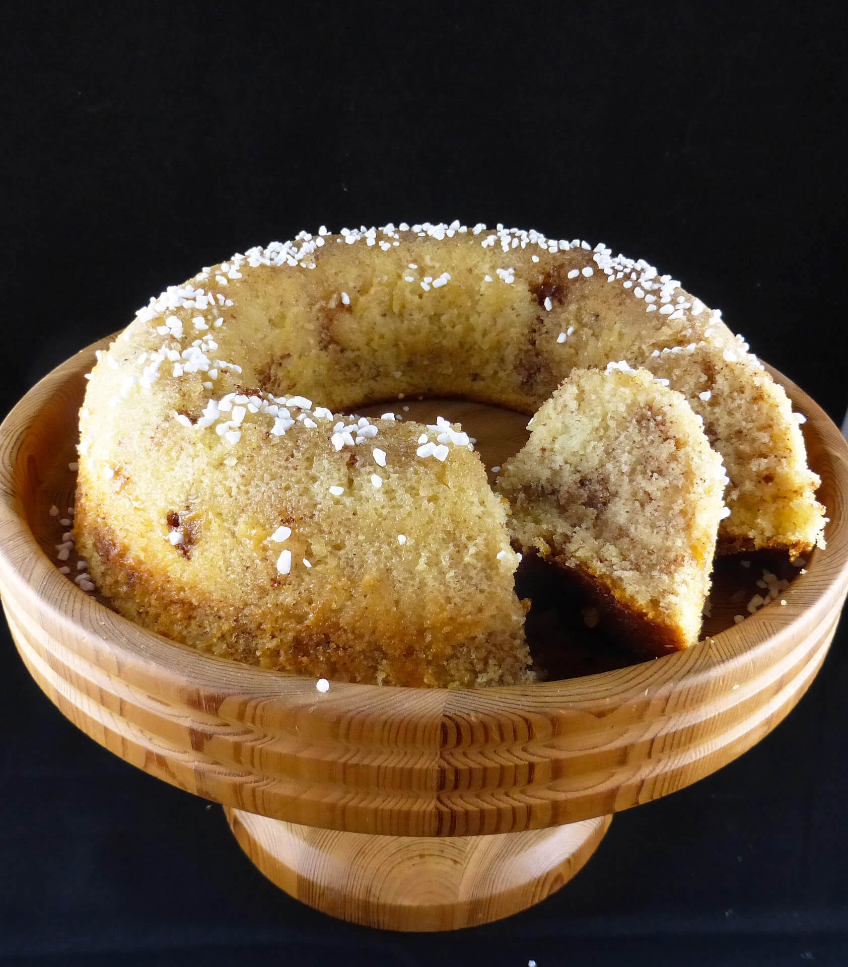 picture of a round sugar cake with two slices cut out