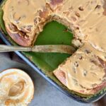 coffee cinnamon buns in a green dish with a knife and a bowl close by