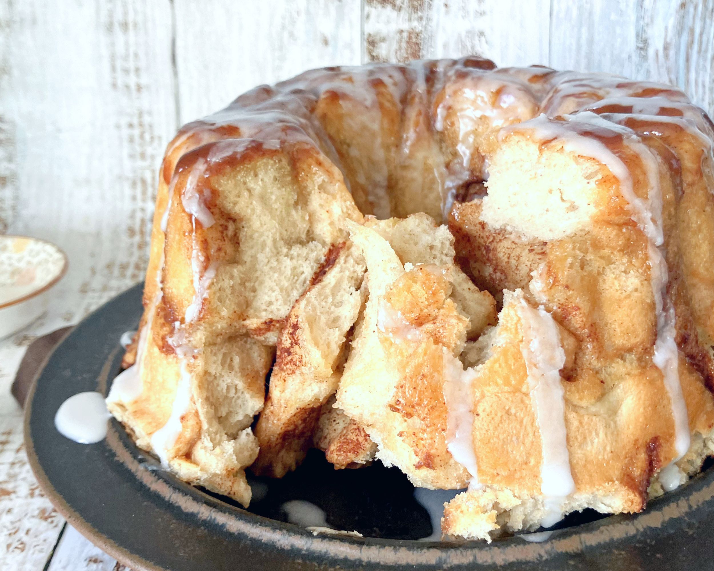 monkey bread on a brown plate with drizzle