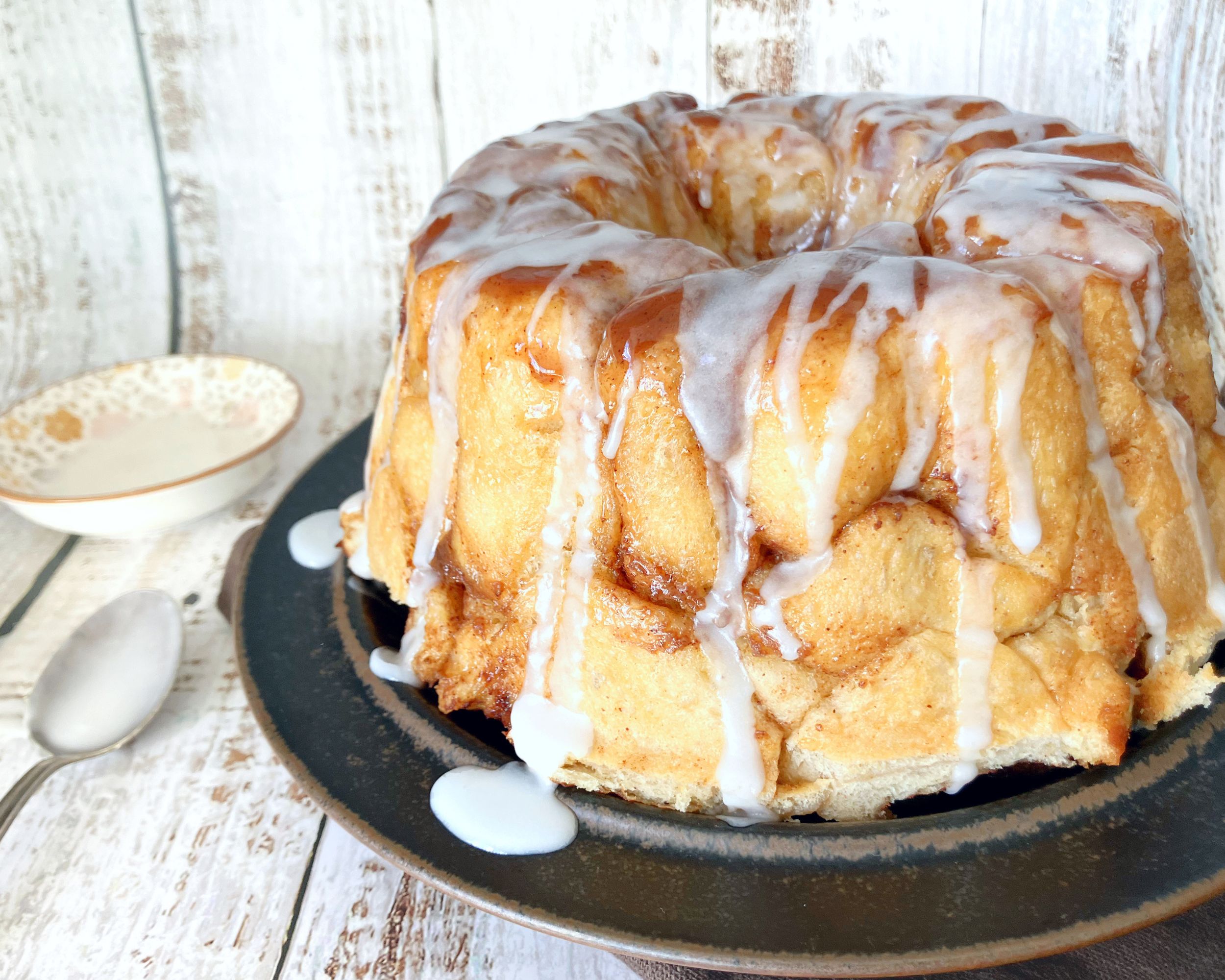 monkey bread on a brown plate with drizzle