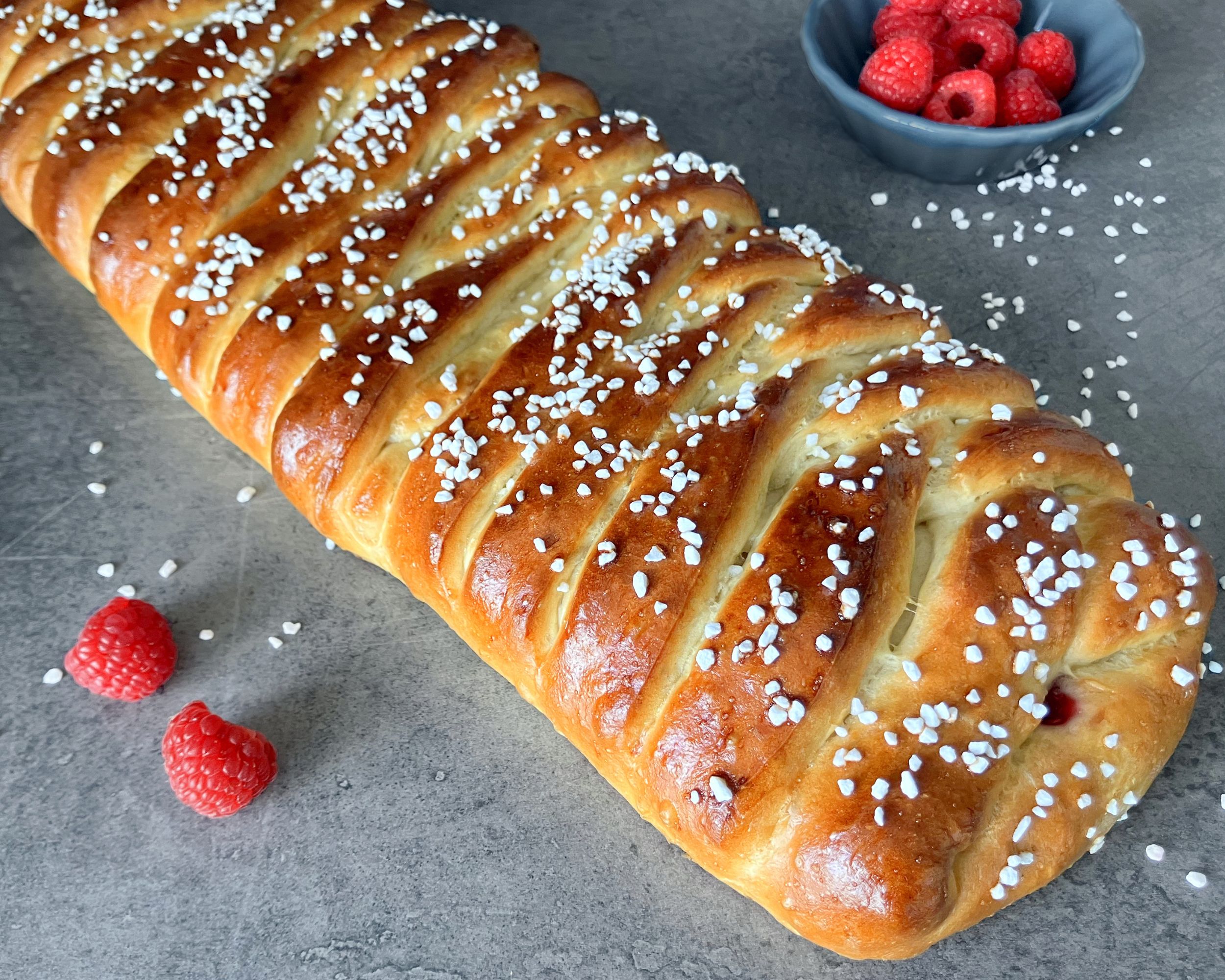 Raspberry bread braid on a blue background