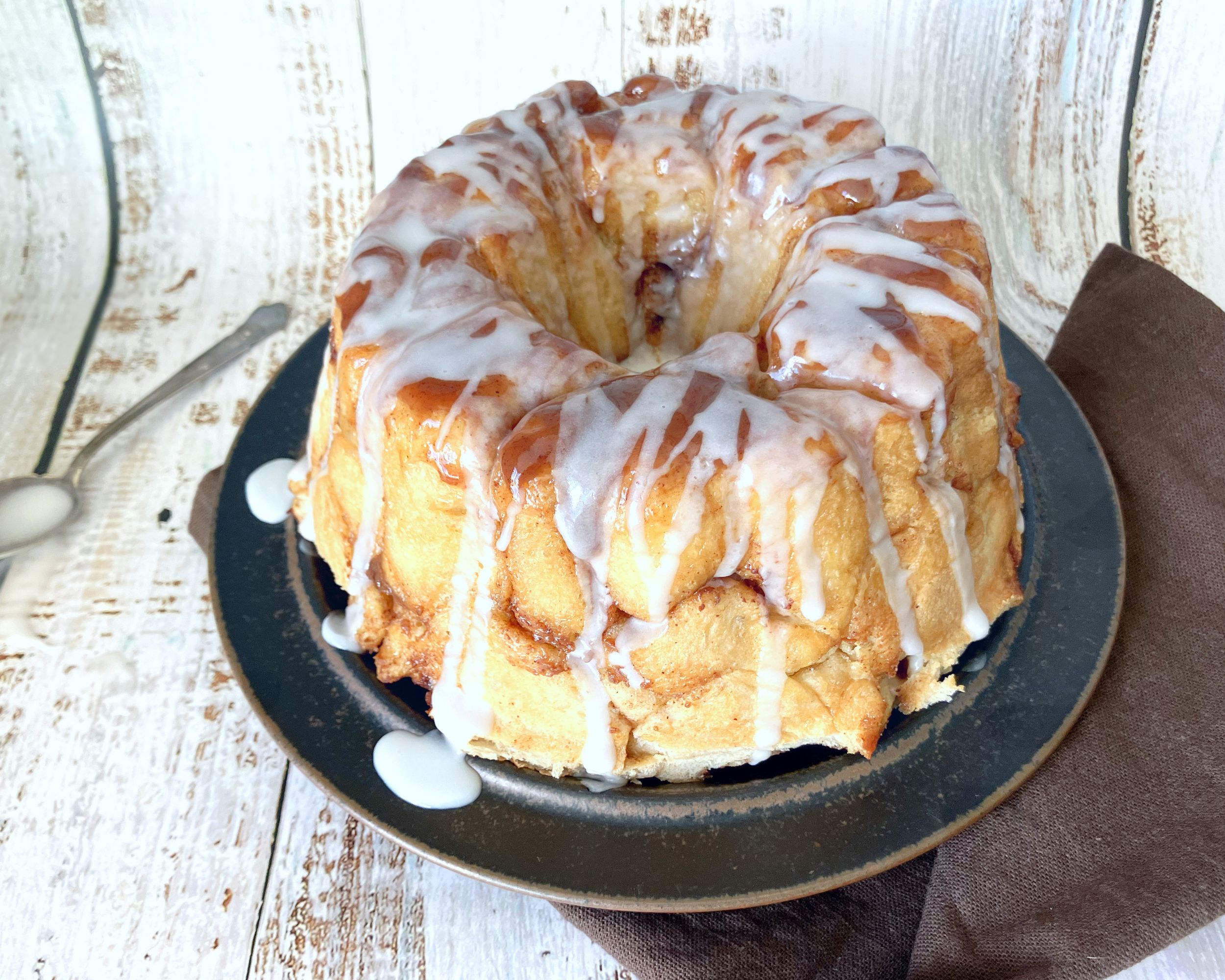 monkey bread on a brown plate with drizzle